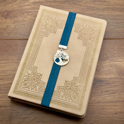 A silver tree of life charm on an elastic Bookband