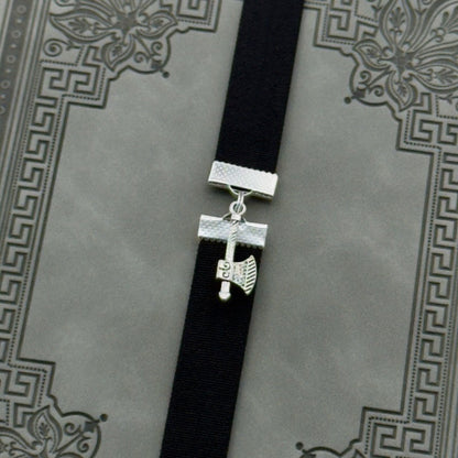 A silver axe charm on an elastic Bookband