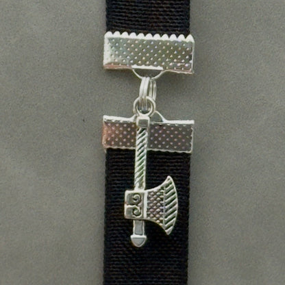 A silver axe charm on an elastic Bookband